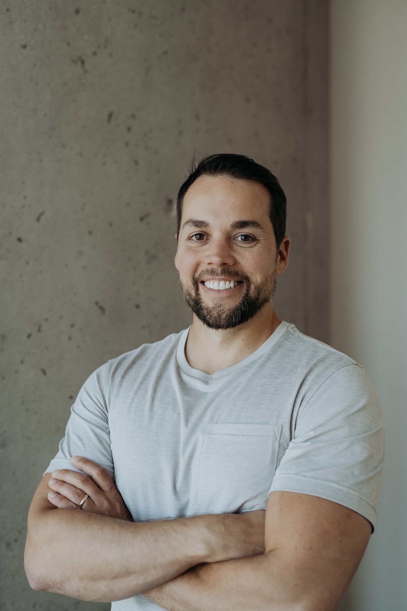 Mike Munroe, smiling, in a white T-shirt